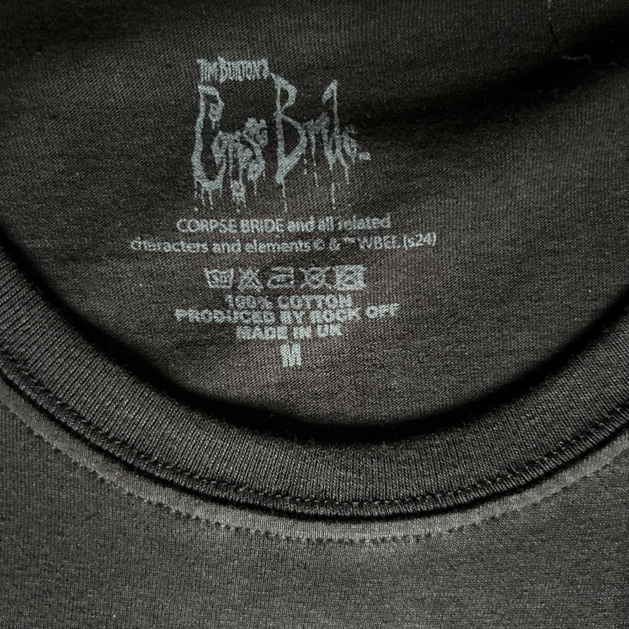 Tim Burton’s Corpse Bride graphic tee featuring Victor and Emily under the moonlit blue scene