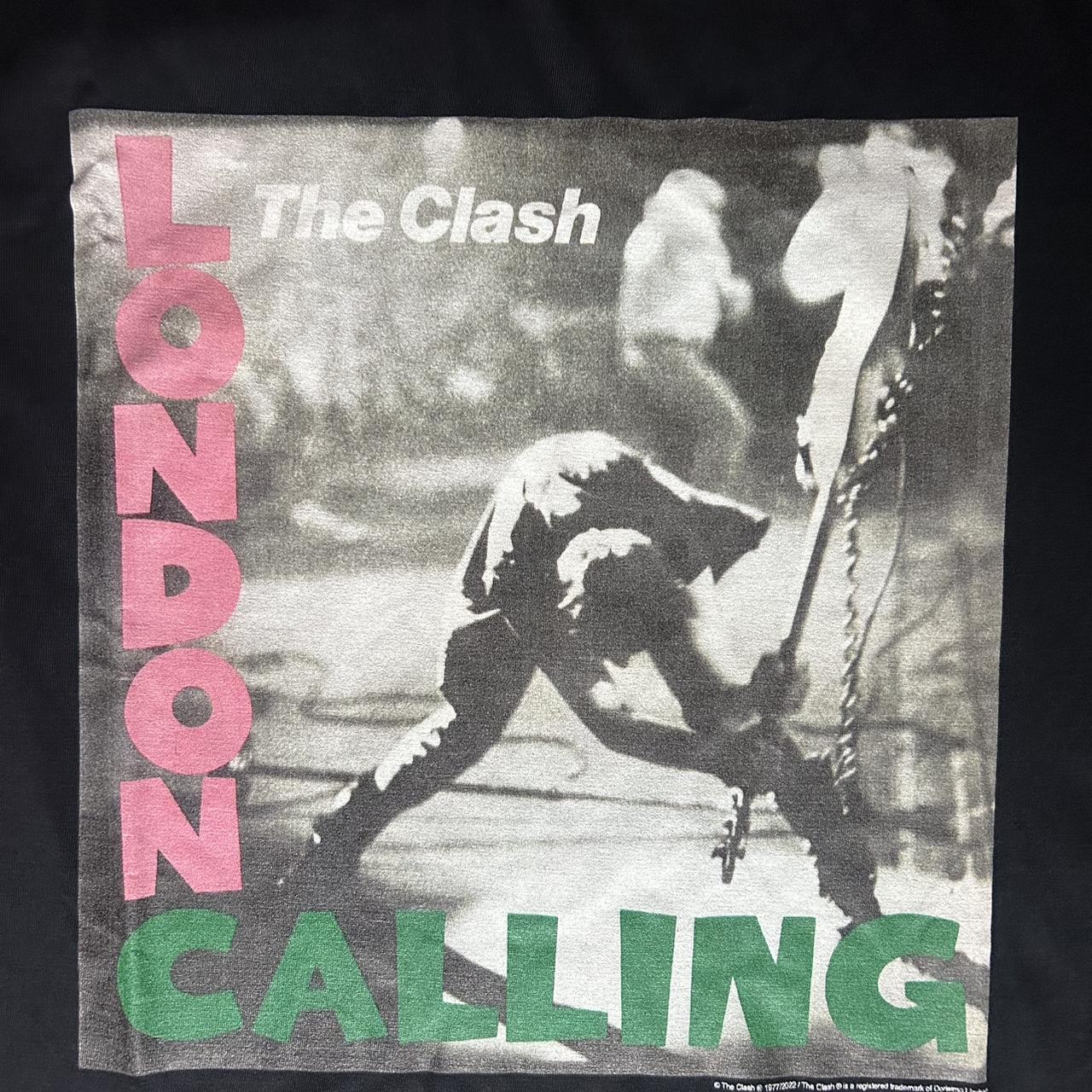 The Clash “London Calling” graphic tee featuring the iconic bass smash artwork with the pink and gre